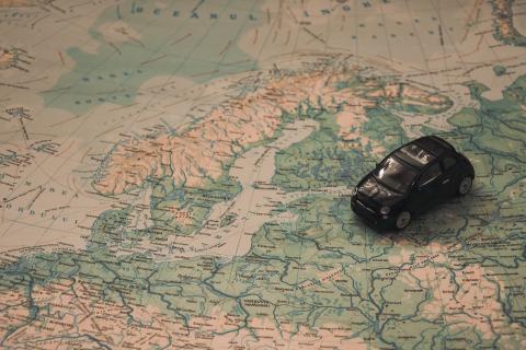 Black Toy Car on World Map Paper